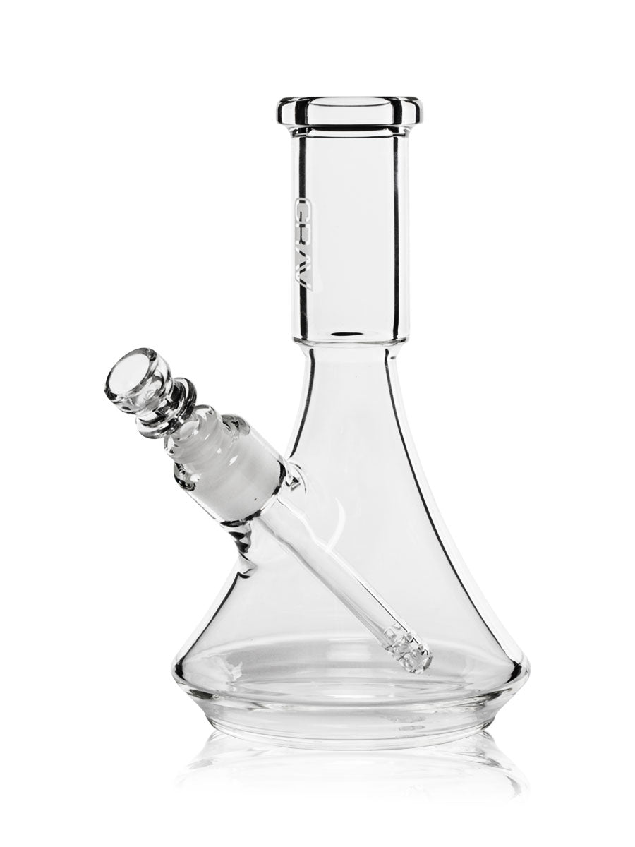 A small, sleek borosilicate glass beaker bong. It stands at 6.7 inches tall and has a base width of 3.9 inches for stable use. From GRAV.